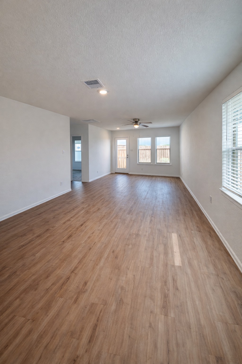 1315 Millers Pass Drive Rosenberg, TX 77471 - Photo 2 of 10 an empty room with wooden floor and windows