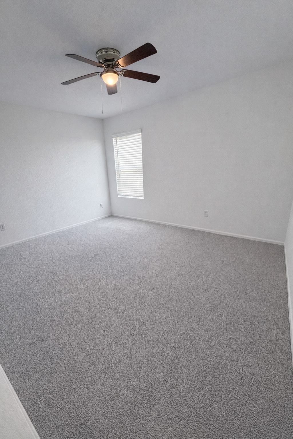 1315 Millers Pass Drive Rosenberg, TX 77471 - Photo 8 of 10 an empty room with a window and a ceiling fan