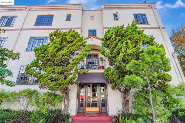a front view of multiple houses with yard