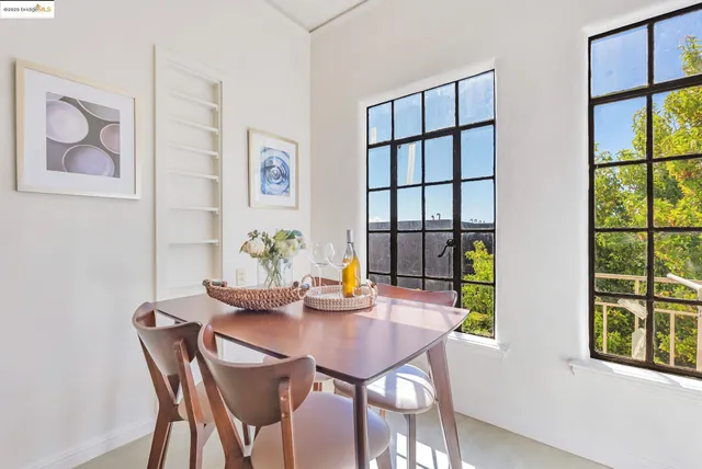 a view of a dining room with furniture a potted plant and a potted plant