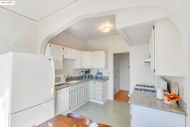 a kitchen with stainless steel appliances a refrigerator sink and cabinets