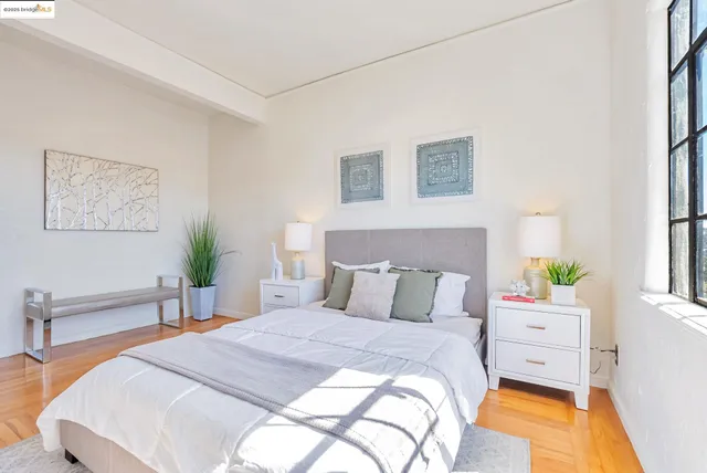 a bedroom with a bed and a potted plant
