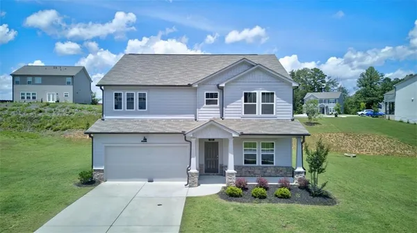 a front view of a house with garden