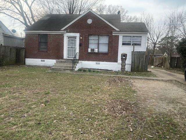 View of front of house featuring crawl space and brick siding