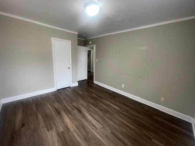 1249 Maria Street Memphis, TN 38122 - Photo 12 of 12 Unfurnished bedroom with ornamental molding, dark wood-style flooring, and a closet