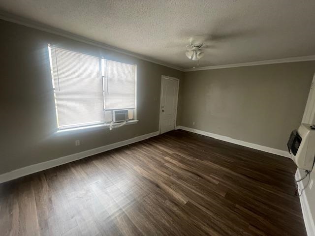 1249 Maria Street Memphis, TN 38122 - Photo 5 of 12 Empty room with crown molding, dark wood-style floors, a textured ceiling, cooling unit, and a ceiling fan