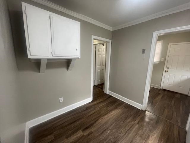 1249 Maria Street Memphis, TN 38122 - Photo 8 of 12 Empty room with dark wood-type flooring and ornamental molding