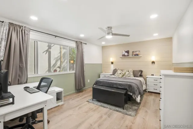 a bedroom with a bed and a desk