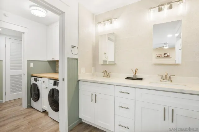 a bathroom with a sink and a washer dryer