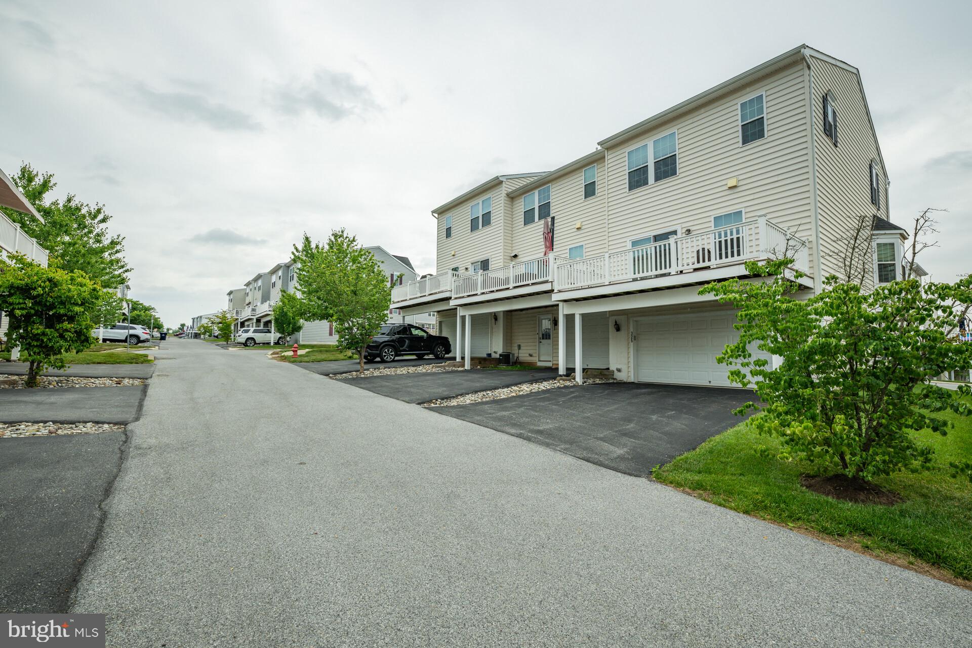 325 Schmidt Road Phoenixville, PA 19460 - Photo 7 of 27 a view of a white building with large windows and a yard