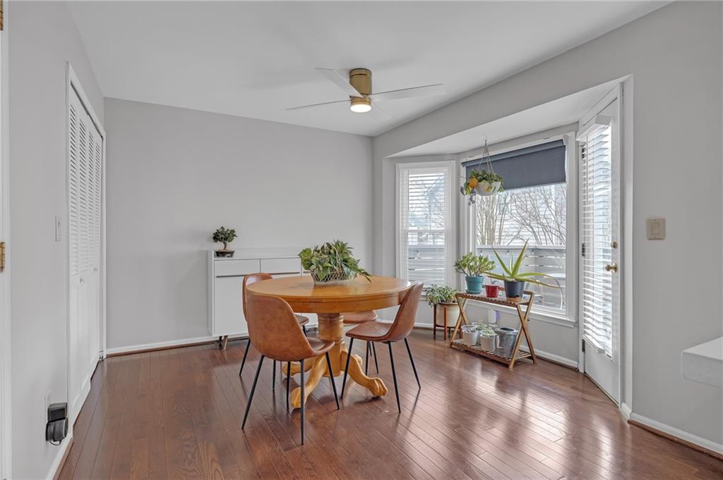 1206 Defoor Court Northwest, Unit 2A Atlanta, GA 30318 - Photo 12 of 36 a view of a dining room with furniture window and wooden floor
