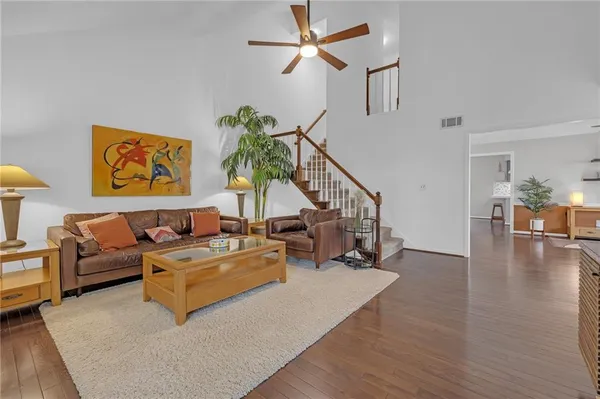 a living room with furniture and a wooden floor