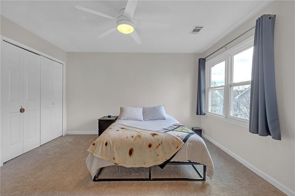 1206 Defoor Court Northwest, Unit 2A Atlanta, GA 30318 - Photo 15 of 36 a bed room with a bed and a window