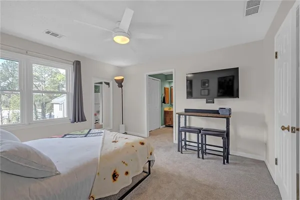a bed room with a bed and a television