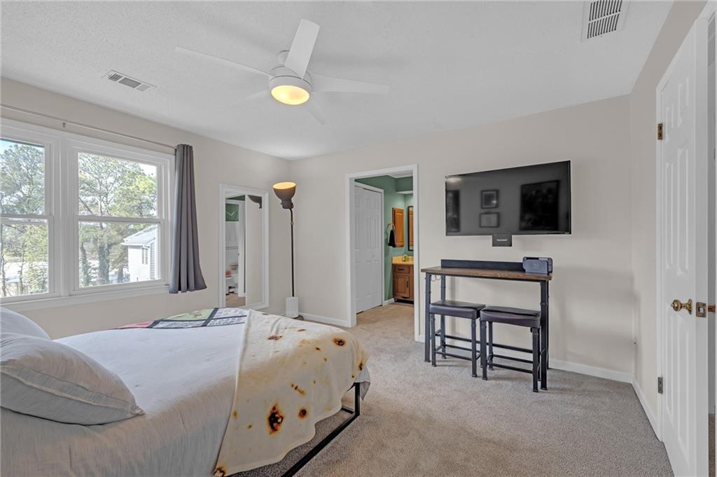 1206 Defoor Court Northwest, Unit 2A Atlanta, GA 30318 - Photo 16 of 36 a bed room with a bed and a television