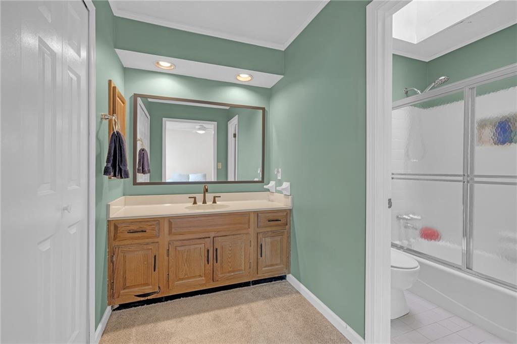 1206 Defoor Court Northwest, Unit 2A Atlanta, GA 30318 - Photo 18 of 36 a bathroom with a sink and a mirror