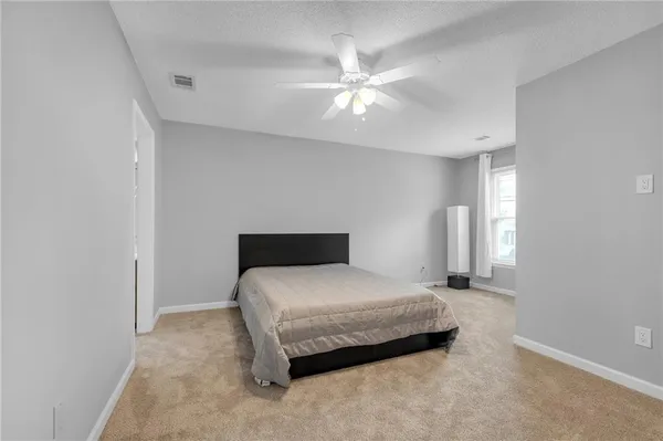 a bedroom with a bed and window