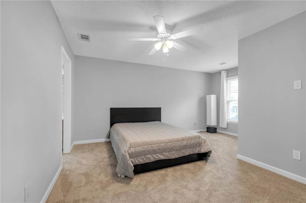 1206 Defoor Court Northwest, Unit 2A Atlanta, GA 30318 - Photo 19 of 36 a bedroom with a bed and window