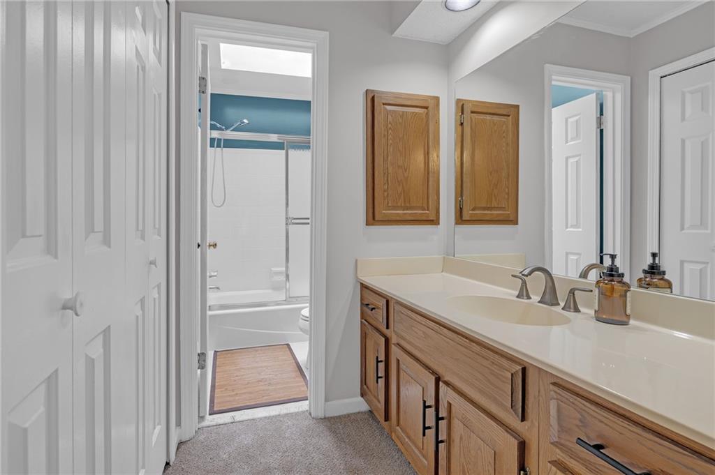 1206 Defoor Court Northwest, Unit 2A Atlanta, GA 30318 - Photo 22 of 36 a bathroom with a sink and a mirror