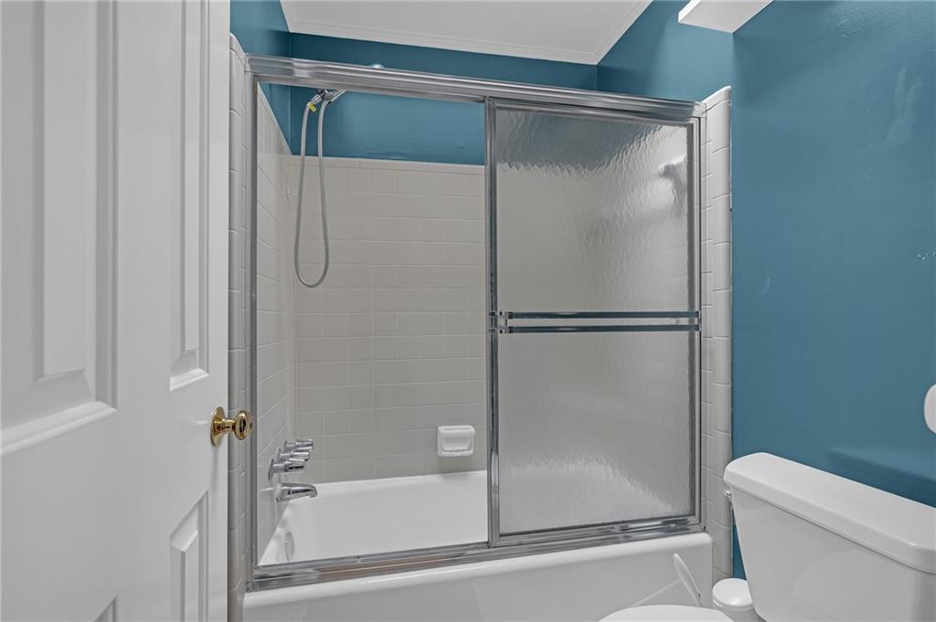 1206 Defoor Court Northwest, Unit 2A Atlanta, GA 30318 - Photo 23 of 36 a bathroom with a glass shower door