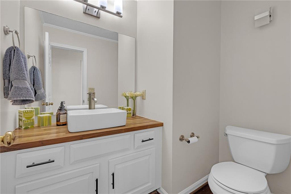 1206 Defoor Court Northwest, Unit 2A Atlanta, GA 30318 - Photo 25 of 36 a bathroom with a toilet sink and mirror