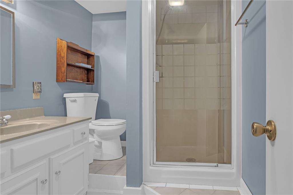 1206 Defoor Court Northwest, Unit 2A Atlanta, GA 30318 - Photo 27 of 36 a bathroom with a sink a toilet and shower