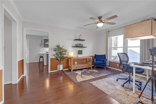 a living room with furniture and wooden floor