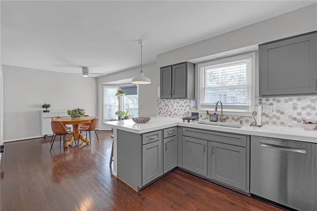 1206 Defoor Court Northwest, Unit 2A Atlanta, GA 30318 - Photo 9 of 36 a kitchen with a sink cabinets and dining table chair