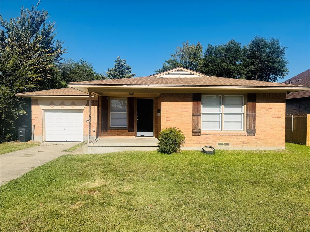 1719 Andrew Street Mesquite, TX 75149 - Photo 1 of 12 a front view of a house with a yard and garage
