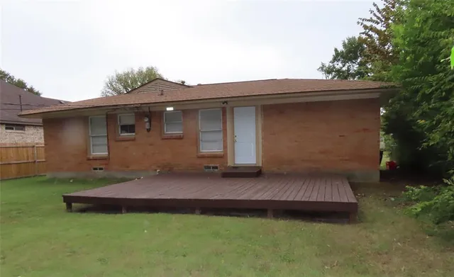 a backyard of a house with table and chairs