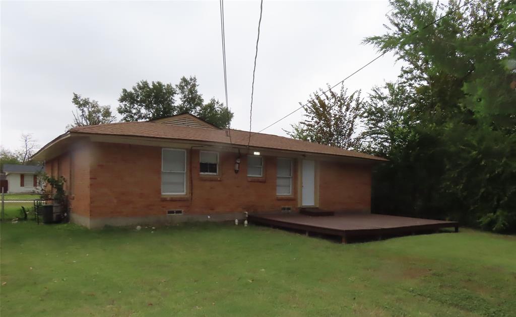 1719 Andrew Street Mesquite, TX 75149 - Photo 6 of 12 a front view of a house with a garden
