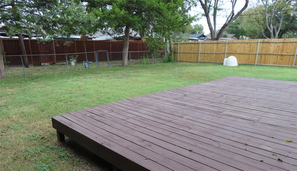 1719 Andrew Street Mesquite, TX 75149 - Photo 7 of 12 a view of a backyard with wooden fence