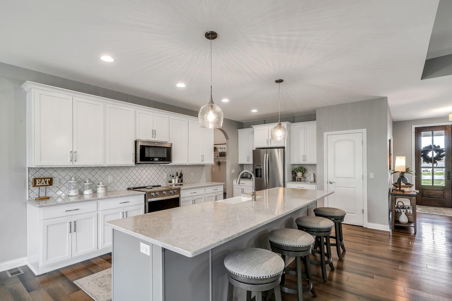 588 Madison Rdg Road Lawrenceburg, IN 47025 - Photo 12 of 71 High end stainless appliances, quartz countertops and a unique white tile backsplash enhance the look and provide additional storage.