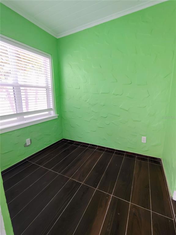 115 145th Avenue, Unit 3 Madeira Beach, FL 33708 - Photo 4 of 12 a view of a room with wooden floor and a window