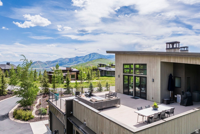 140 West Vista Road Kamas, UT 84036 - Photo 98 of 101 Expansive exterior deck, mountain backdrop, flat roofline, floor-to-ceiling windows, and multiple outdoor lighting fixtures