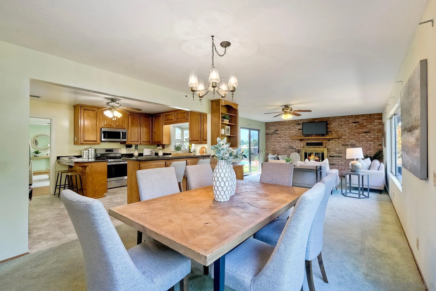 1346 Pepper Villa Drive El Cajon, CA 92021 - Photo 11 of 25 a dining room with wooden floor a chandelier a wooden table and chairs