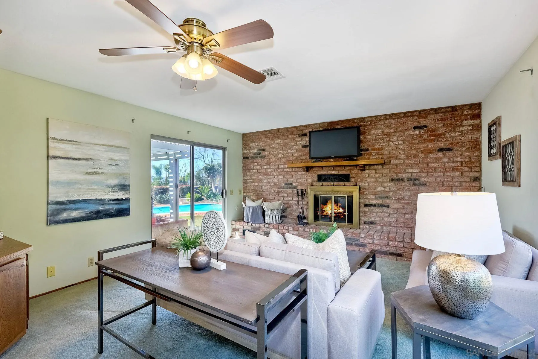 1346 Pepper Villa Drive El Cajon, CA 92021 - Photo 12 of 25 a living room with furniture a flat screen tv and a fireplace