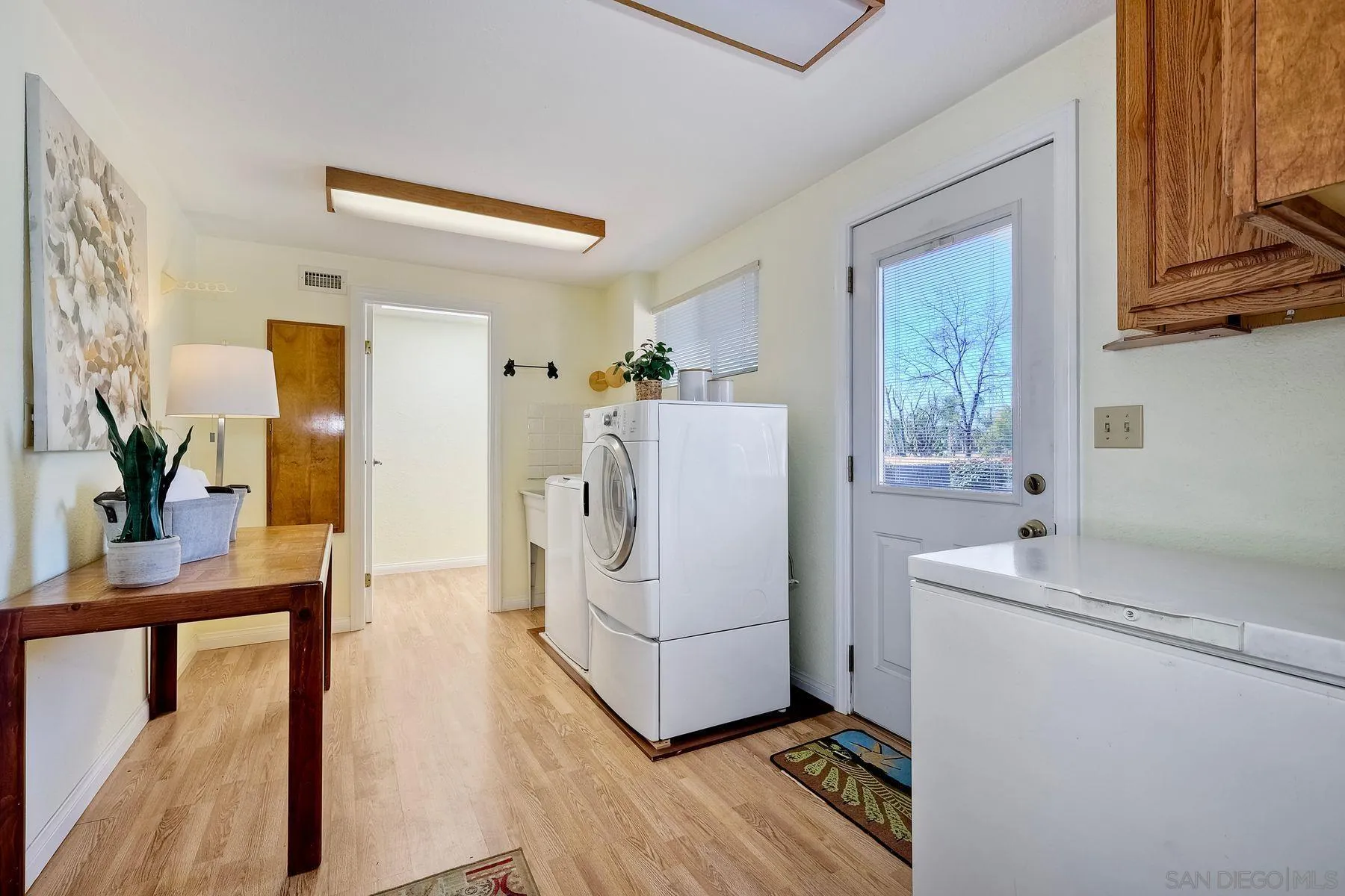 1346 Pepper Villa Drive El Cajon, CA 92021 - Photo 18 of 25 a utility room with cabinets washer and dryer