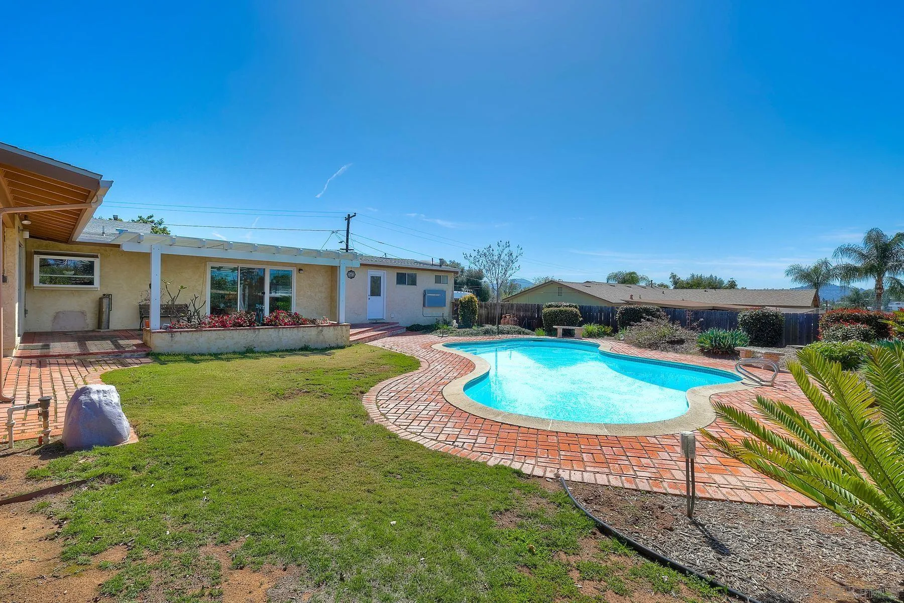 1346 Pepper Villa Drive El Cajon, CA 92021 - Photo 21 of 25 a front view of a house with swimming pool having outdoor seating