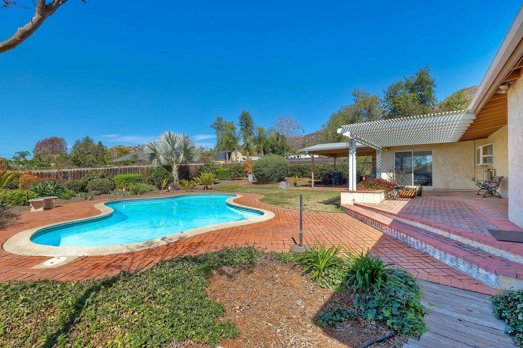 1346 Pepper Villa Drive El Cajon, CA 92021 - Photo 24 of 25 a view of a swimming pool with lawn chairs and plants