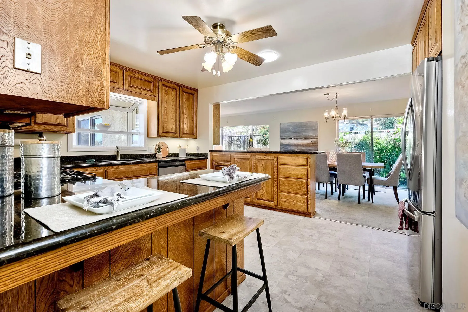 1346 Pepper Villa Drive El Cajon, CA 92021 - Photo 5 of 25 a kitchen with stainless steel appliances granite countertop table chairs sink and cabinets