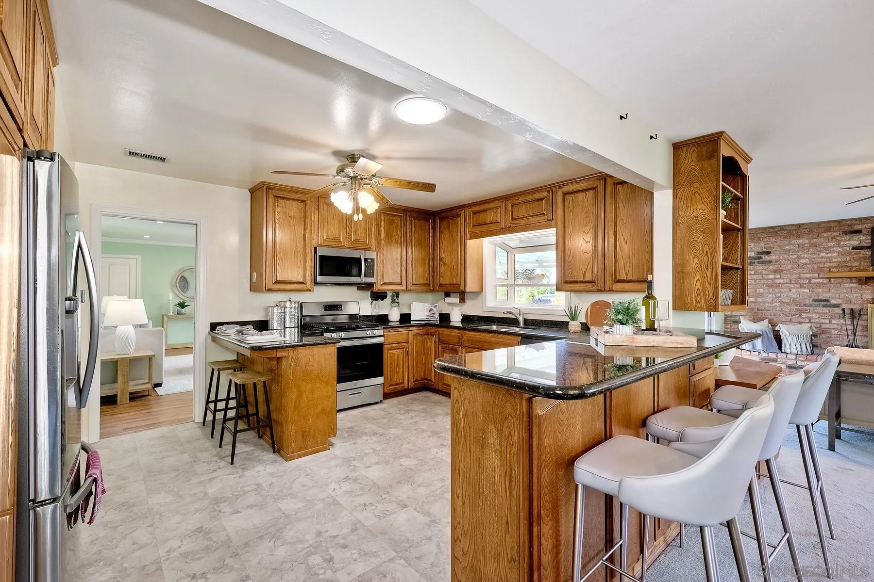 1346 Pepper Villa Drive El Cajon, CA 92021 - Photo 8 of 25 a kitchen with living room and chairs