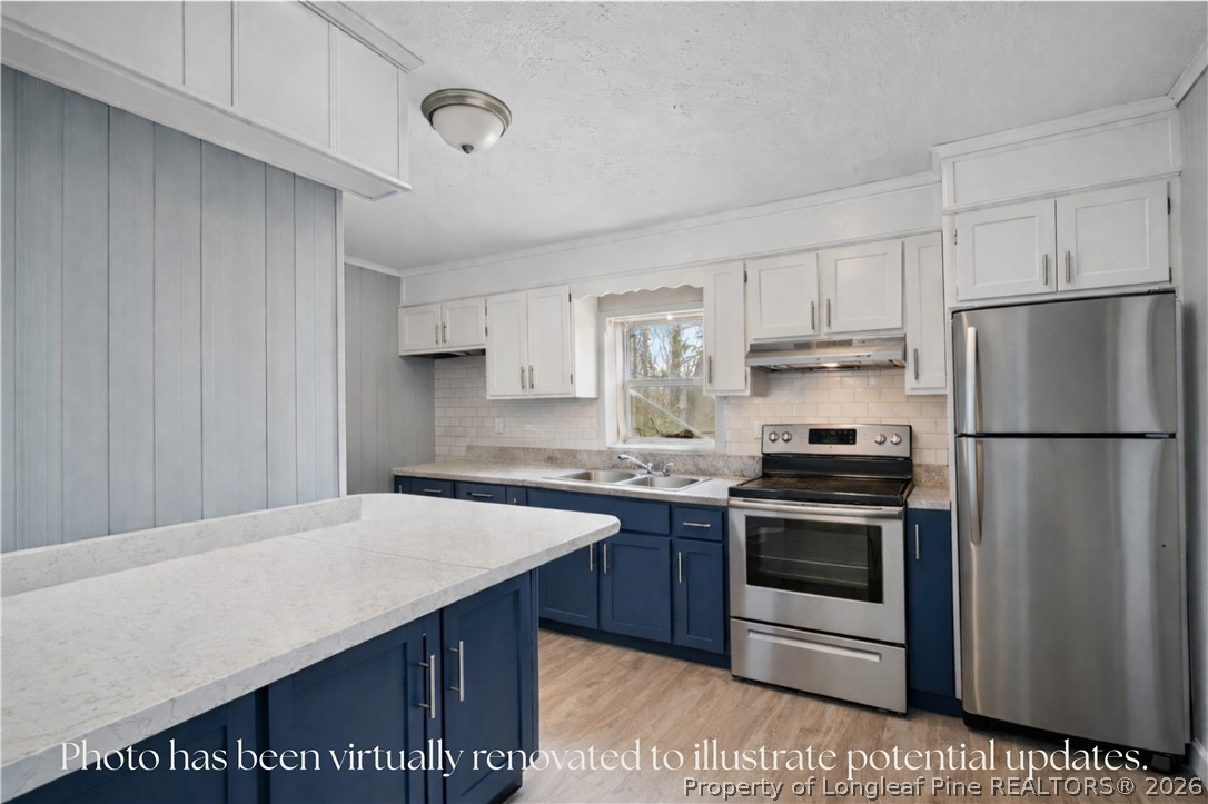 217 South Grove Avenue Rockingham, NC 28379 - Photo 11 of 37 a kitchen with stainless steel appliances a stove a sink and a refrigerator