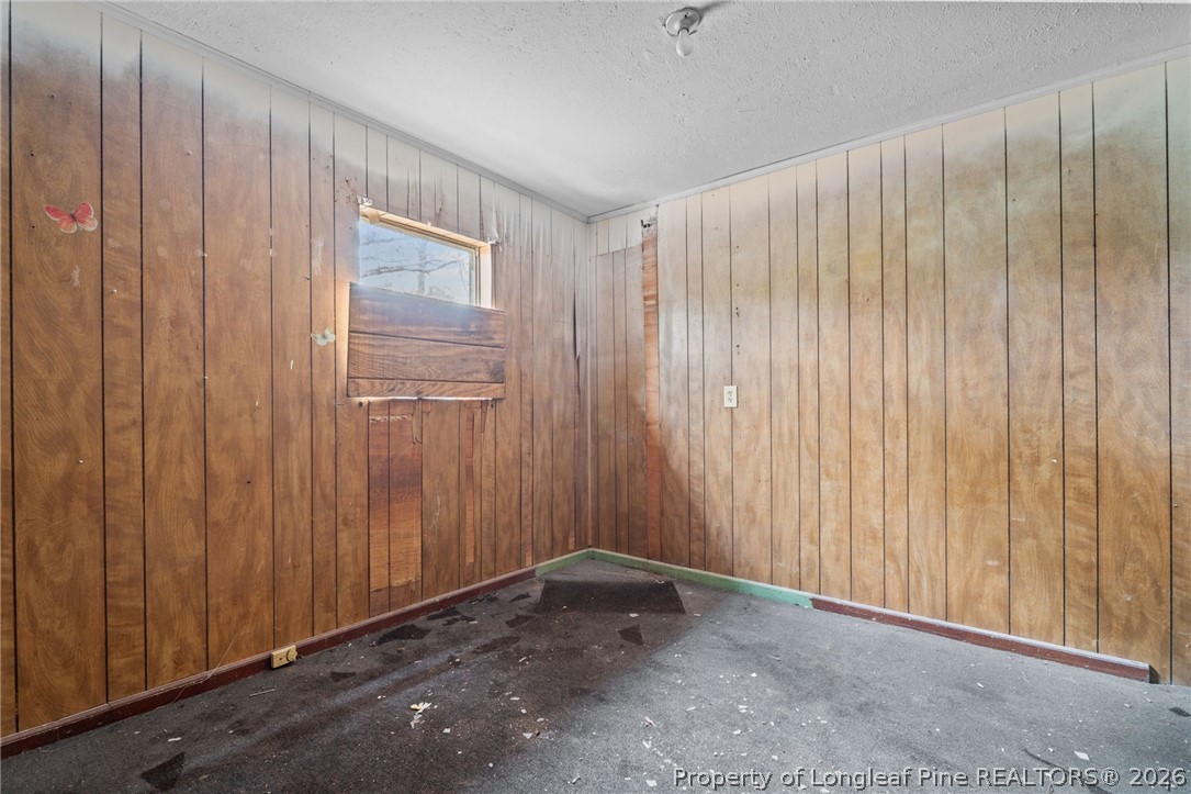 217 South Grove Avenue Rockingham, NC 28379 - Photo 13 of 37 a view of an empty room with a wooden door