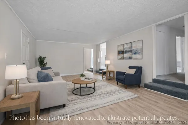 a living room with furniture a rug and a lamp