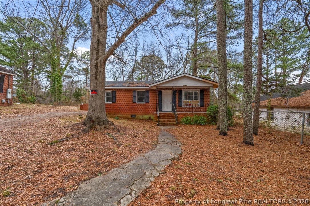 217 South Grove Avenue Rockingham, NC 28379 - Photo 37 of 37 a backyard of a house with large trees and wooden fence
