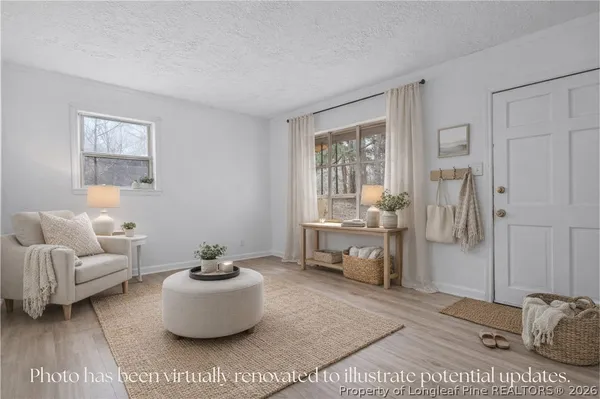 a living room with furniture and a potted plant