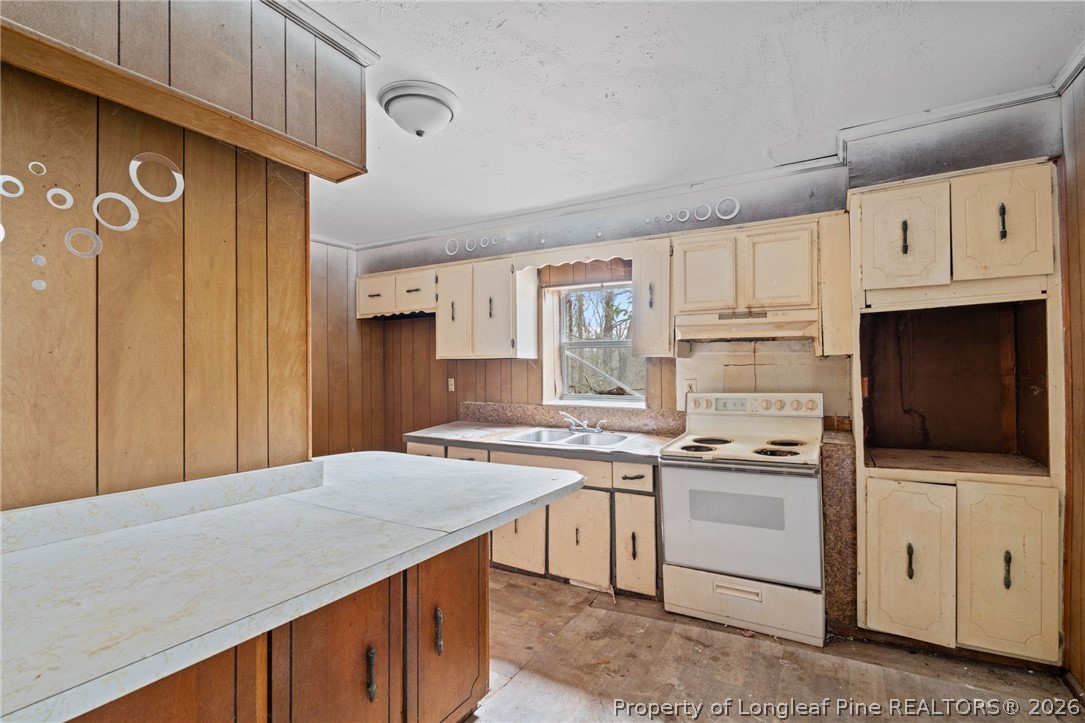 217 South Grove Avenue Rockingham, NC 28379 - Photo 10 of 37 a kitchen with stainless steel appliances a stove a sink and a refrigerator