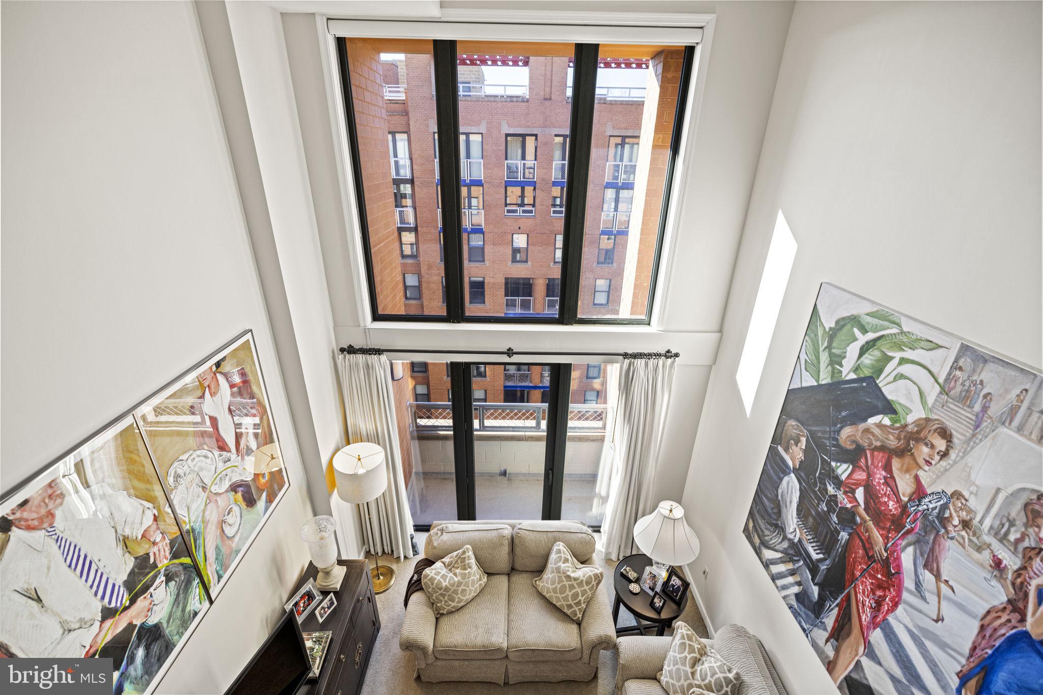 616 E Street Northwest, Unit 1152 Washington, DC 20004 - Photo 11 of 92 a living room with furniture and a painting on the wall