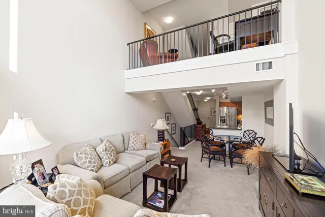 a bathroom with a granite countertop sink a toilet and a mirror